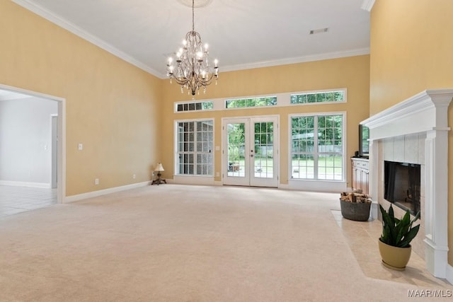 204 St Thomas Ave, Wetumpka, AL 36092 - unfurnished living room with carpet, crown molding, a chandelier, a tiled fireplace, and a towering ceiling