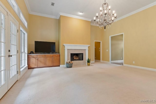 204 St Thomas Ave, Wetumpka, AL 36092 - unfurnished living room featuring light colored carpet, crown molding, a chandelier, a tile fireplace, and french doors