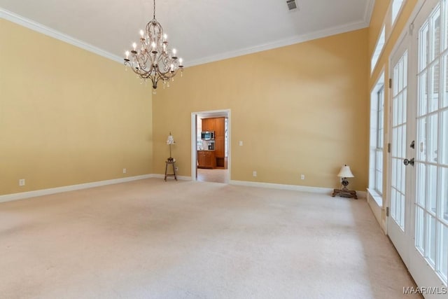 204 St Thomas Ave, Wetumpka, AL 36092 - spare room featuring a chandelier, ornamental molding, light carpet, and french doors