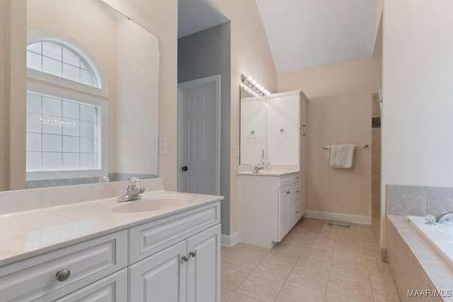 204 St Thomas Ave, Wetumpka, AL 36092 - bathroom with two vanities, a garden tub, tile patterned floors, and lofted ceiling