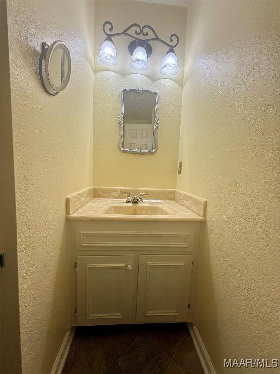 1604 Cobblestone Ct, Montgomery, AL 36117 - bathroom featuring vanity, tile patterned flooring, and a textured wall
