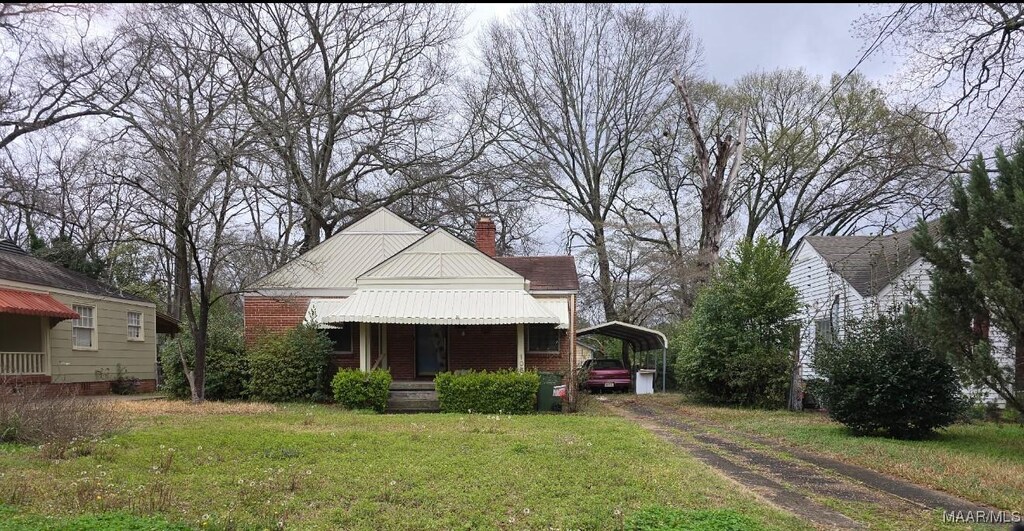 105 Dunn Dr, Montgomery, AL 36109 - view of front of property featuring a carport, a front lawn, a chimney, asphalt driveway, and a porch