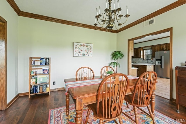 4015 Snowdoun Chambers Rd, Montgomery, AL 36116 - dining area featuring crown molding, a chandelier, and wood finished floors