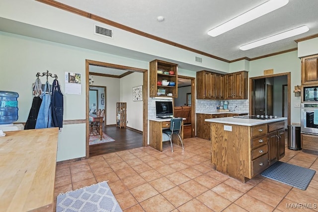 4015 Snowdoun Chambers Rd, Montgomery, AL 36116 - kitchen with black appliances, decorative backsplash, crown molding, light countertops, and a kitchen island