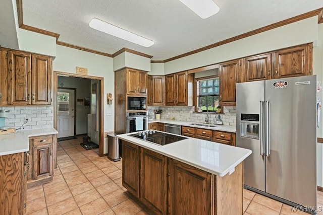 4015 Snowdoun Chambers Rd, Montgomery, AL 36116 - kitchen with black appliances, light tile patterned floors, tasteful backsplash, light countertops, and a textured ceiling