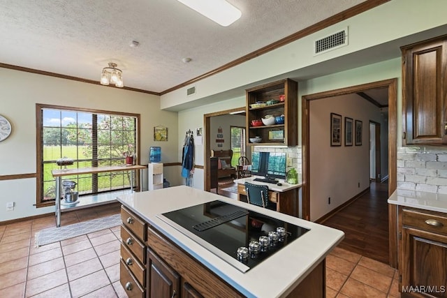 4015 Snowdoun Chambers Rd, Montgomery, AL 36116 - kitchen with a textured ceiling, light countertops, a desk, light tile patterned flooring, and crown molding