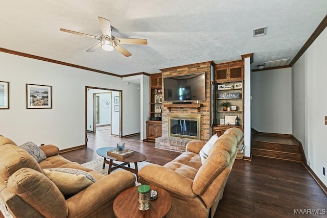 4015 Snowdoun Chambers Rd, Montgomery, AL 36116 - living room with crown molding, ceiling fan, dark wood finished floors, a fireplace, and stairs