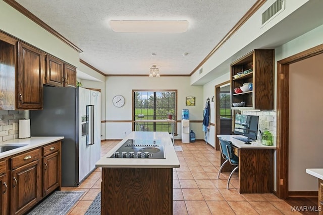 4015 Snowdoun Chambers Rd, Montgomery, AL 36116 - kitchen with a textured ceiling, a kitchen island, black electric stovetop, light countertops, and high quality fridge
