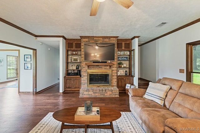 4015 Snowdoun Chambers Rd, Montgomery, AL 36116 - living room featuring dark wood-style floors, ornamental molding, a ceiling fan, and a fireplace
