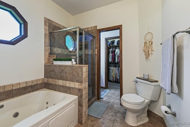 4015 Snowdoun Chambers Rd, Montgomery, AL 36116 - bathroom with a whirlpool tub, a shower stall, tile patterned flooring, and a spacious closet