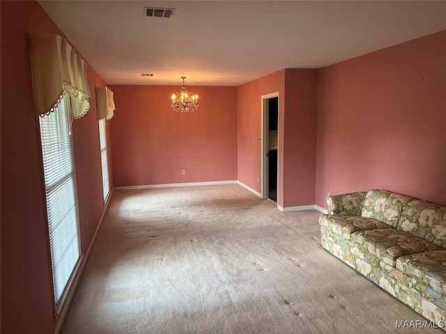 216 Cone Dr, Selma, AL 36701 - unfurnished living room with light carpet and a chandelier