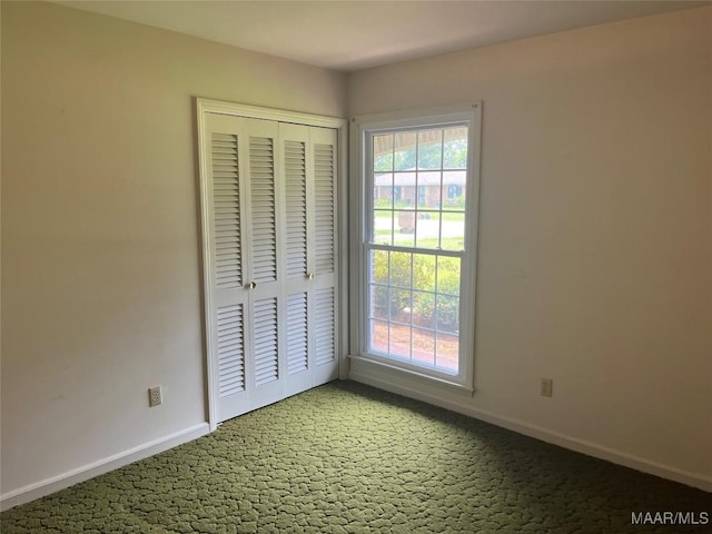216 Cone Dr, Selma, AL 36701 - unfurnished bedroom featuring light carpet, multiple windows, and a closet