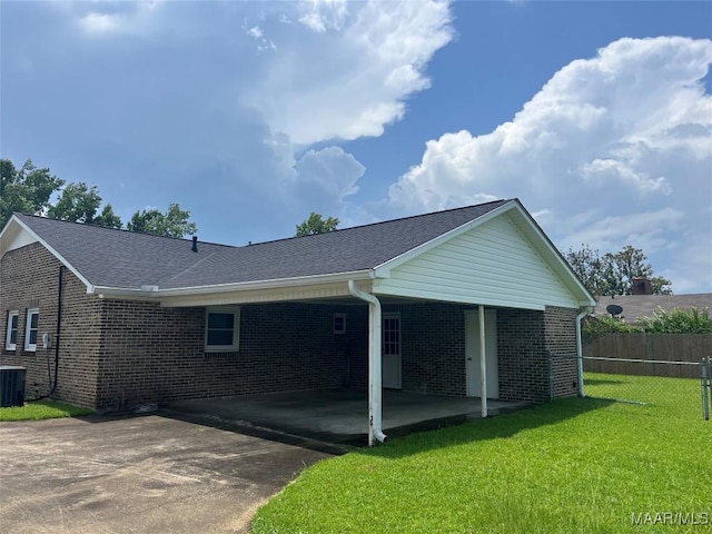 216 Cone Dr, Selma, AL 36701 - view of side of home featuring brick siding, driveway, a carport, and a shingled roof