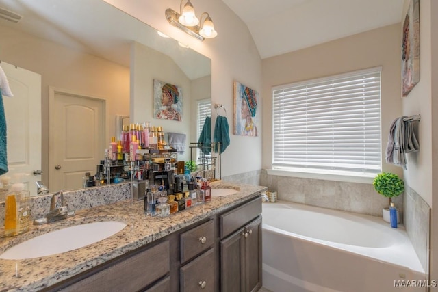 6642 Triston Way, Montgomery, AL 36117 - bathroom with vaulted ceiling, double vanity, and a garden tub