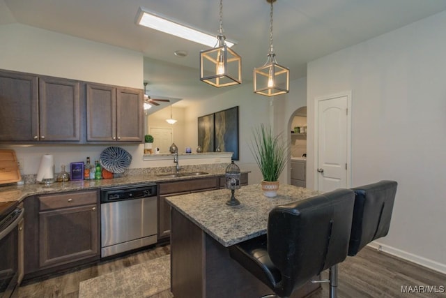 6642 Triston Way, Montgomery, AL 36117 - kitchen with appliances with stainless steel finishes, dark wood finished floors, washer / clothes dryer, a kitchen breakfast bar, and light stone counters