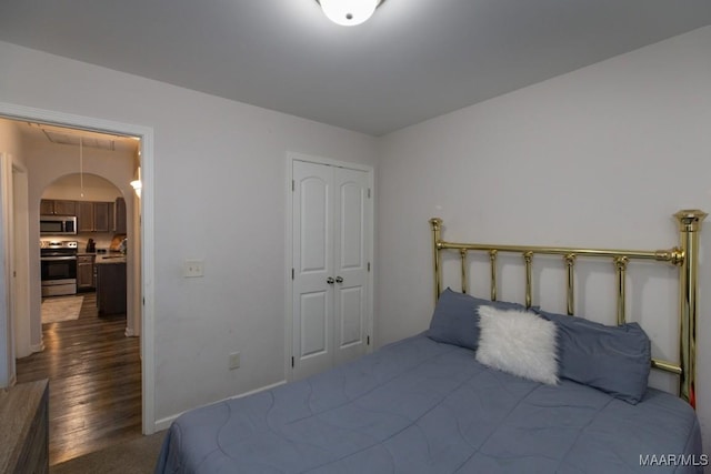 6642 Triston Way, Montgomery, AL 36117 - bedroom featuring a closet, arched walkways, and dark wood-style flooring