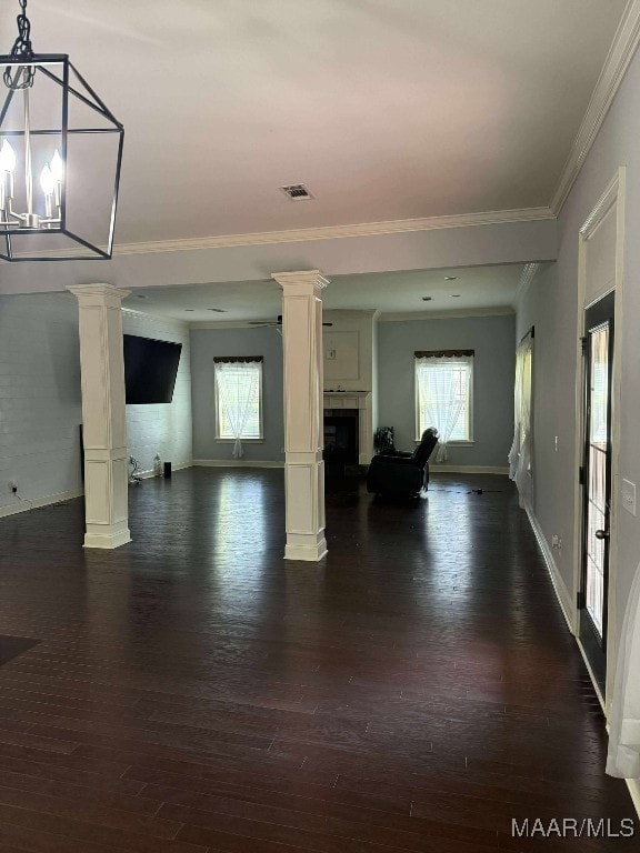 312 Sherwood Trl, Wetumpka, AL 36093 - unfurnished living room with ornate columns, dark wood-style floors, healthy amount of natural light, a fireplace, and ornamental molding