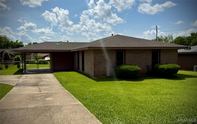 5204 Patricia Ln, Montgomery, AL 36108 - ranch-style home featuring a front yard, concrete driveway, a carport, and brick siding