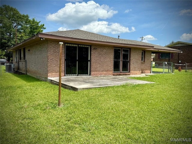 5204 Patricia Ln, Montgomery, AL 36108 - back of house featuring a patio area, brick siding, a gate, and a shingled roof