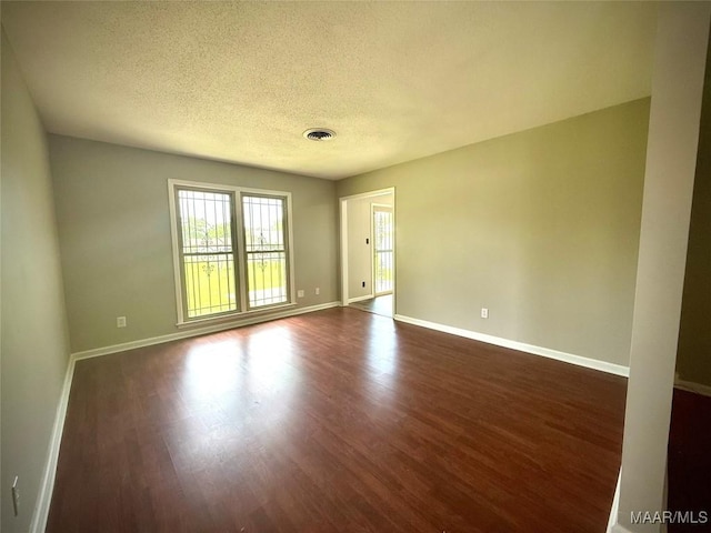 5204 Patricia Ln, Montgomery, AL 36108 - unfurnished room featuring dark wood-style floors and a textured ceiling