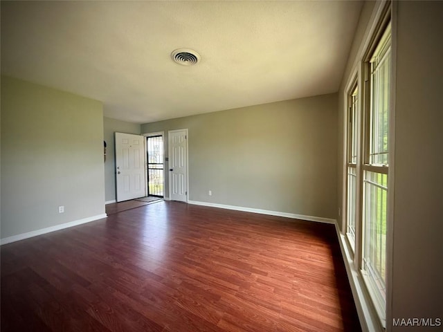 5204 Patricia Ln, Montgomery, AL 36108 - spare room with baseboards and dark wood-type flooring