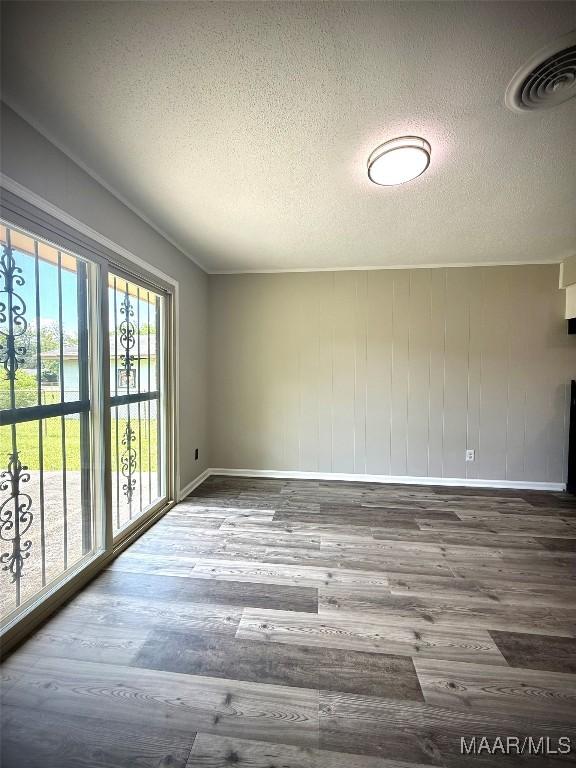 5204 Patricia Ln, Montgomery, AL 36108 - empty room featuring a textured ceiling and wood finished floors