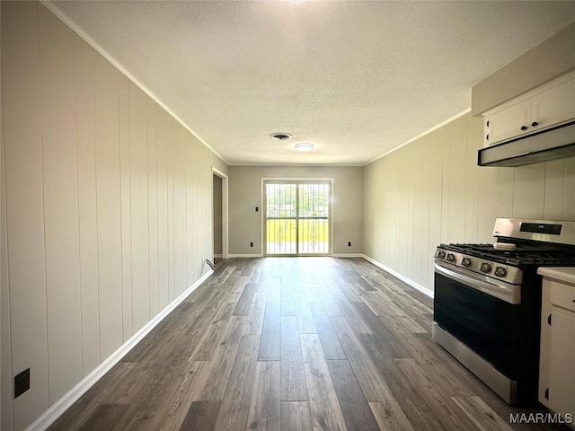 5204 Patricia Ln, Montgomery, AL 36108 - kitchen featuring stainless steel range with gas stovetop, dark wood-type flooring, ventilation hood, a textured ceiling, and white cabinetry