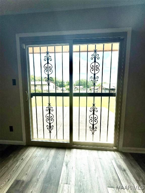 5204 Patricia Ln, Montgomery, AL 36108 - doorway with baseboards and wood finished floors