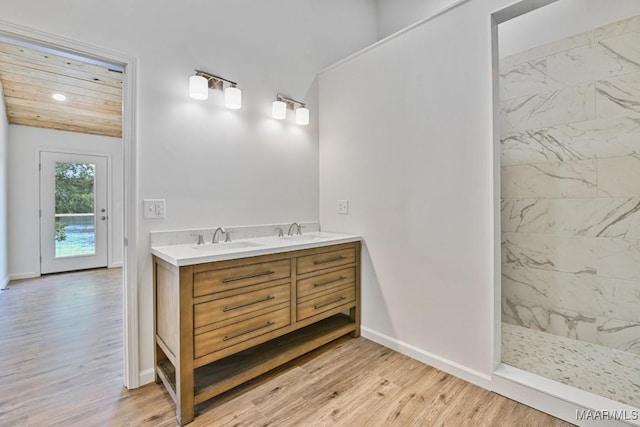 1415 Gold Mine Branch Rd, Marbury, AL 36051 - bathroom featuring a tile shower, double vanity, wood finished floors, and recessed lighting