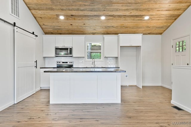 1415 Gold Mine Branch Rd, Marbury, AL 36051 - kitchen with stainless steel microwave, electric stove, a barn door, vaulted ceiling, and wooden ceiling