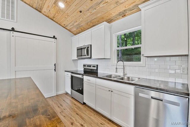 1415 Gold Mine Branch Rd, Marbury, AL 36051 - kitchen with appliances with stainless steel finishes, wooden ceiling, dark countertops, vaulted ceiling, and light wood-style flooring