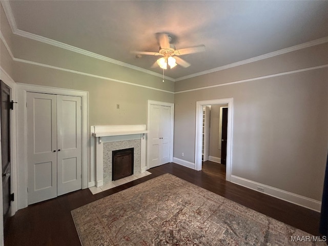 2412 College St, Montgomery, AL 36106 - unfurnished living room with dark wood-type flooring, ceiling fan, crown molding, and a tiled fireplace