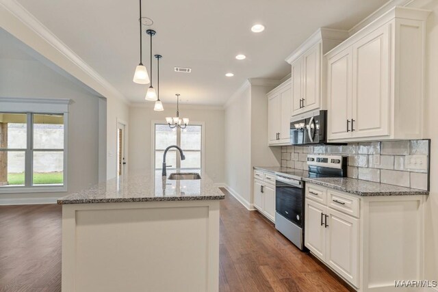 79 Birchwood Ln, Wetumpka, AL 36093 - kitchen featuring appliances with stainless steel finishes, ornamental molding, tasteful backsplash, dark wood finished floors, and an island with sink