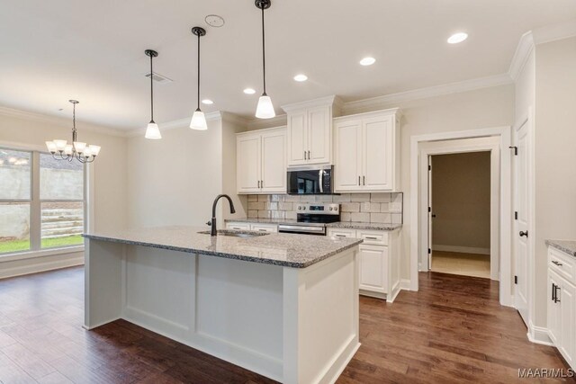 79 Birchwood Ln, Wetumpka, AL 36093 - kitchen featuring appliances with stainless steel finishes, crown molding, dark wood-style floors, tasteful backsplash, and an island with sink