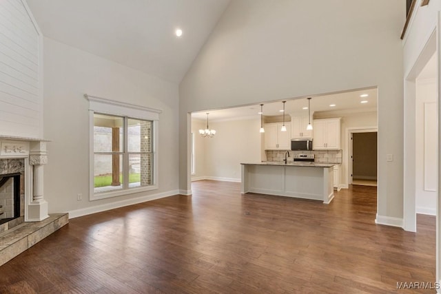 79 Birchwood Ln, Wetumpka, AL 36093 - unfurnished living room with high vaulted ceiling, a premium fireplace, a chandelier, dark wood finished floors, and recessed lighting