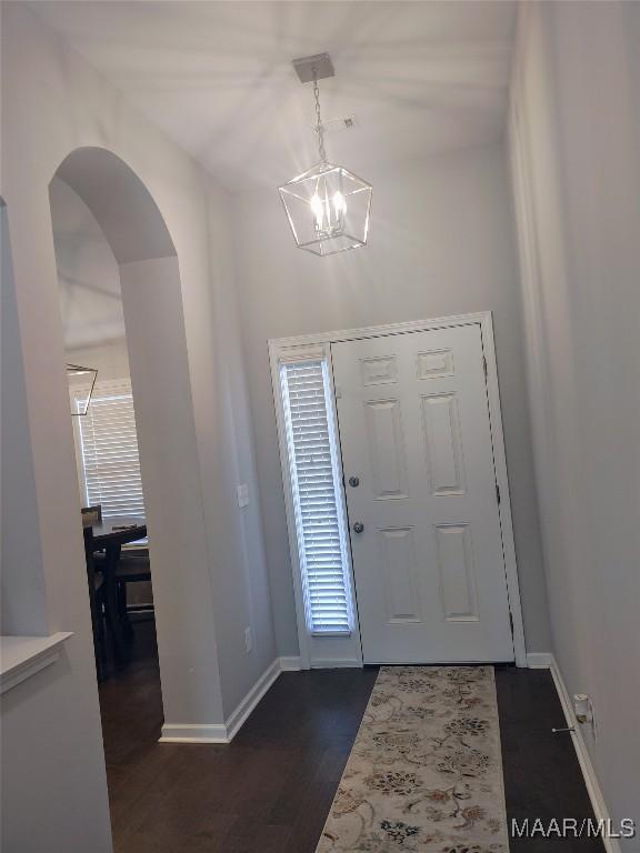 512 Lismore Pl, Montgomery, AL 36117 - entryway featuring a chandelier, arched walkways, and dark wood-style flooring
