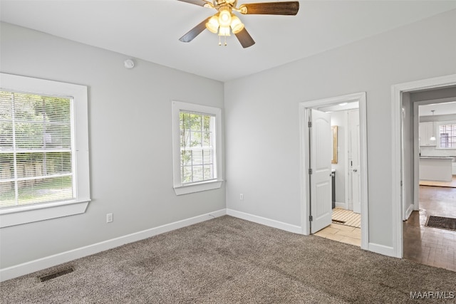 1310 Woodward Ave, Montgomery, AL 36106 - unfurnished bedroom with carpet flooring, ceiling fan, and ensuite bathroom