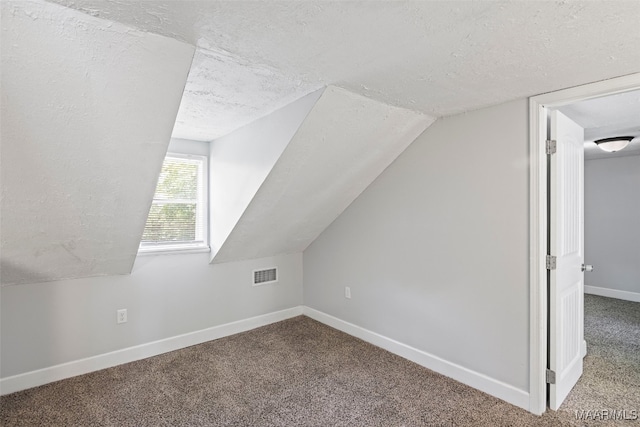 1310 Woodward Ave, Montgomery, AL 36106 - bonus room featuring a textured ceiling, carpet flooring, and vaulted ceiling