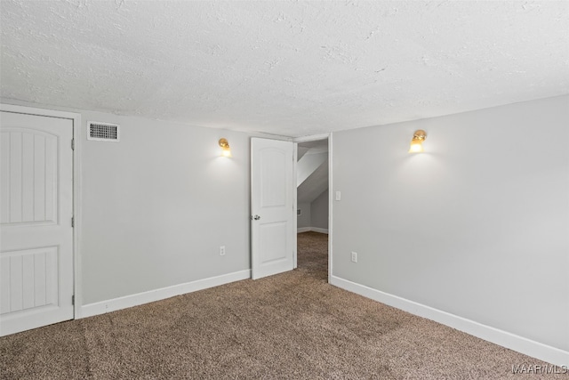1310 Woodward Ave, Montgomery, AL 36106 - spare room featuring a textured ceiling and carpet floors