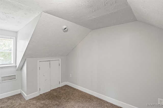 1310 Woodward Ave, Montgomery, AL 36106 - additional living space with a textured ceiling, lofted ceiling, and carpet flooring