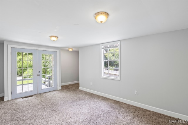 1310 Woodward Ave, Montgomery, AL 36106 - carpeted empty room with french doors and plenty of natural light