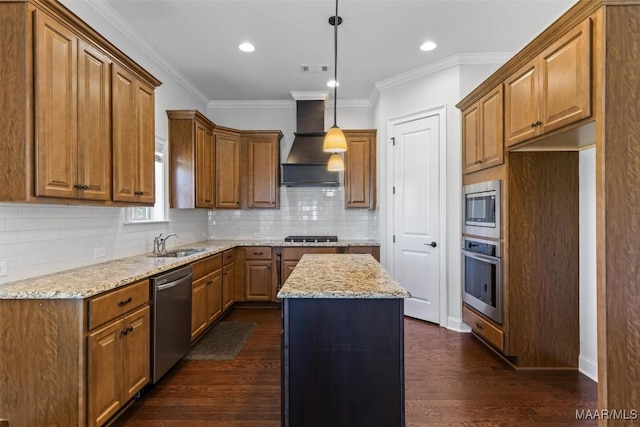 8465 Melbourne Cir, Montgomery, AL 36117 - kitchen featuring appliances with stainless steel finishes, premium range hood, brown cabinets, light stone counters, and a kitchen island