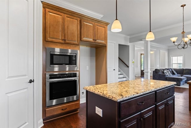 8465 Melbourne Cir, Montgomery, AL 36117 - kitchen with stainless steel appliances, light stone counters, crown molding, ornate columns, and dark wood-type flooring