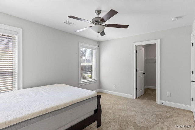 8465 Melbourne Cir, Montgomery, AL 36117 - bedroom featuring light colored carpet, a ceiling fan, and a walk in closet