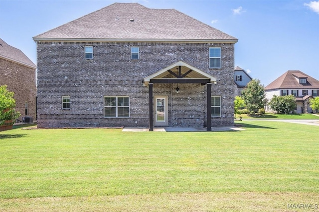 8465 Melbourne Cir, Montgomery, AL 36117 - back of house featuring brick siding, a yard, a patio area, and roof with shingles