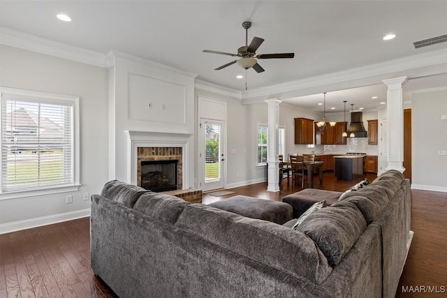 8465 Melbourne Cir, Montgomery, AL 36117 - living room featuring ornate columns, healthy amount of natural light, a ceiling fan, recessed lighting, and crown molding