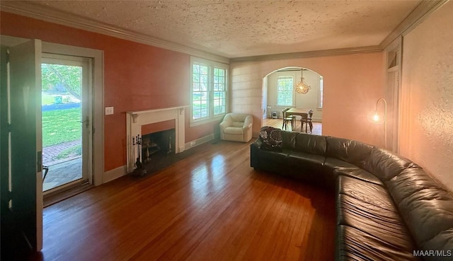 3319 Lexington Rd, Montgomery, AL 36106 - living area with wood finished floors, ornamental molding, arched walkways, a fireplace with flush hearth, and a textured ceiling