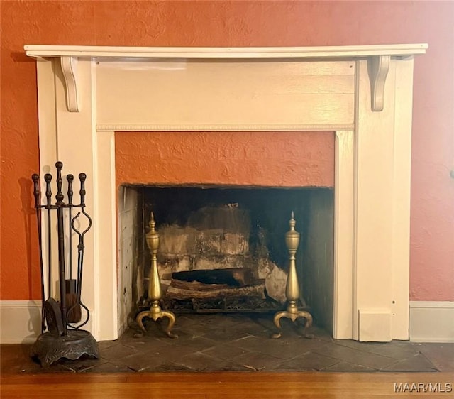 3319 Lexington Rd, Montgomery, AL 36106 - detailed view of wood finished floors, a fireplace, and a textured wall