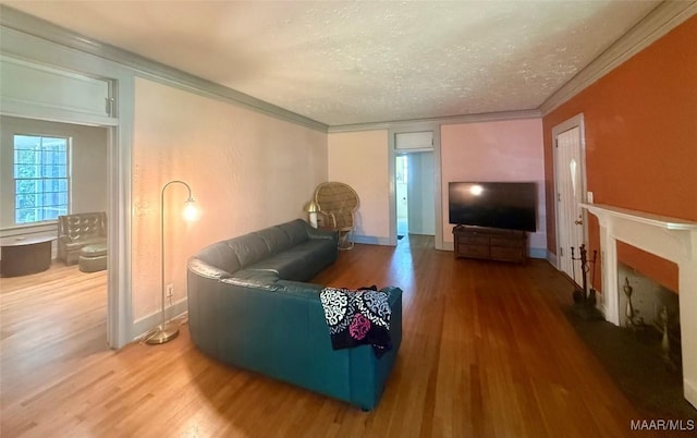 3319 Lexington Rd, Montgomery, AL 36106 - living area featuring wood finished floors, a textured ceiling, a fireplace, and crown molding