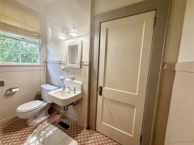 3319 Lexington Rd, Montgomery, AL 36106 - bathroom featuring toilet and a wainscoted wall